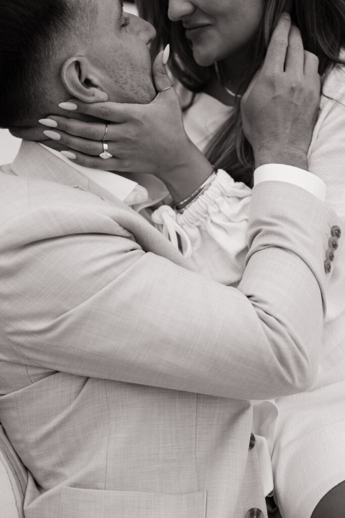 Authentic embrace between newly engaged couple during intimate Orange County beach house proposal session