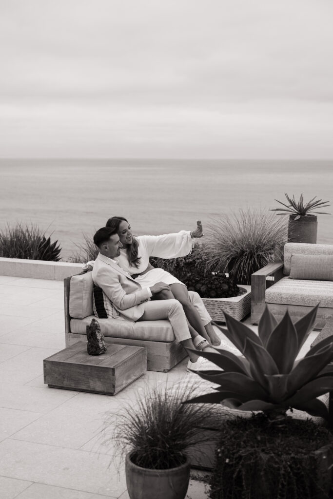 Candid moment of bride wiping happy tears during San Clemente beach house proposal captured by luxury photographer