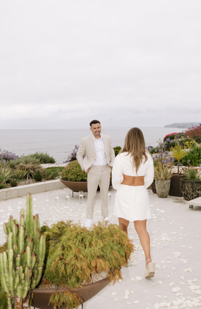 Bride covers face in surprise during San Clemente beach house proposal captured by Orange County photographer