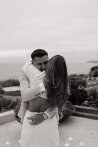 Beach house proposal photography shows emotional proposal moment with Pacific Ocean and coastal views