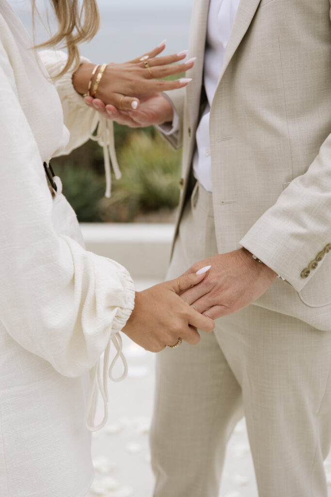 Engagement ring detail shot with San Clemente coastline backdrop during luxury beach house proposal photography session