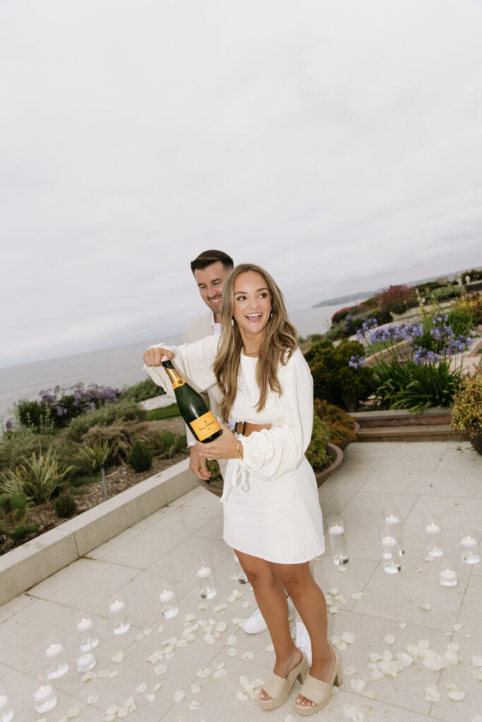 Newly engaged couple celebrates on private deck overlooking Pacific Ocean after San Clemente proposal