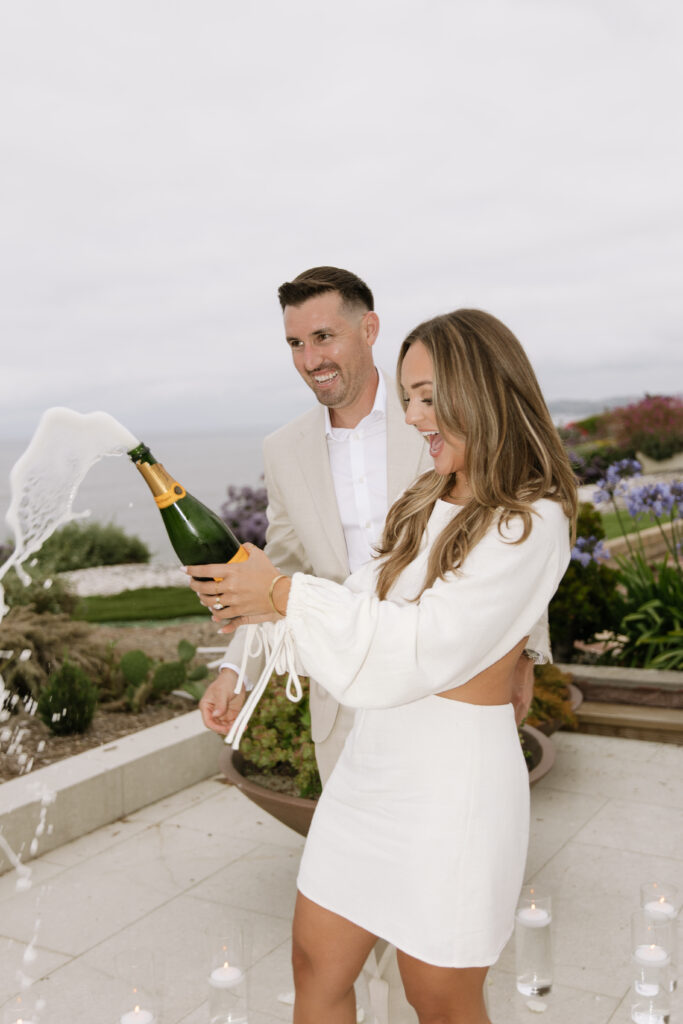 Newly engaged couple celebrates on private deck overlooking Pacific Ocean after San Clemente proposal