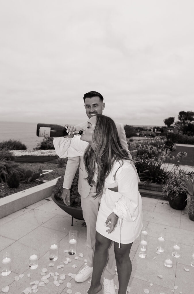 Pure joy and laughter during beach house engagement moment captured by Southern California proposal photographer