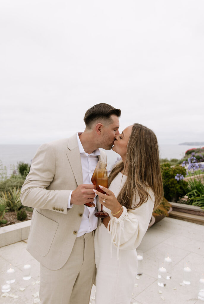 Newly engaged couple poses for romantic portraits during golden hour San Clemente beach house proposal session