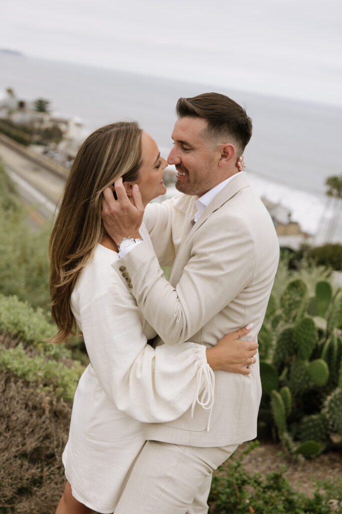 Orange County proposal photographer creates romantic engagement portraits with ocean sunset backdrop