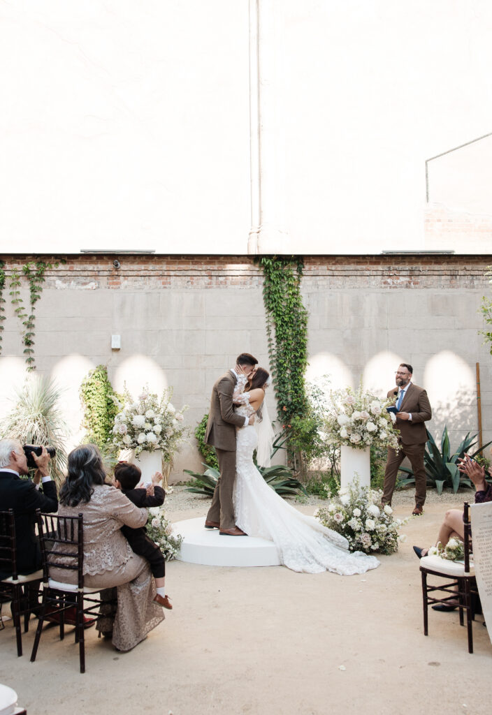 Bride & groom have first kiss and are walking down the isle. 