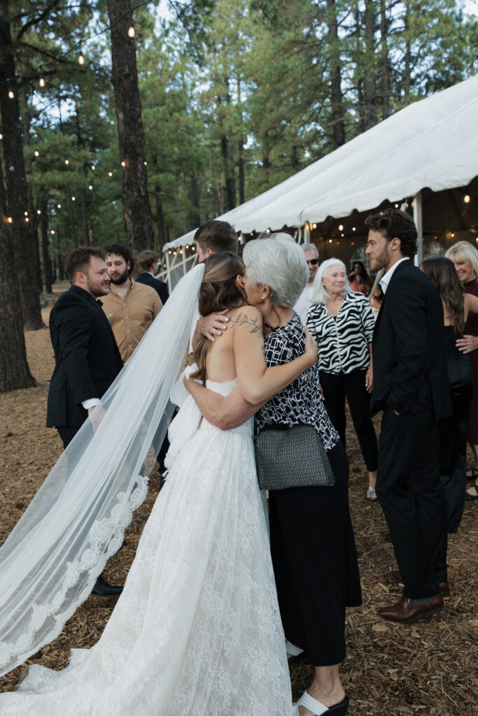 Candid moments of bride and groom with wedding guests in Flagstaff Arizona.