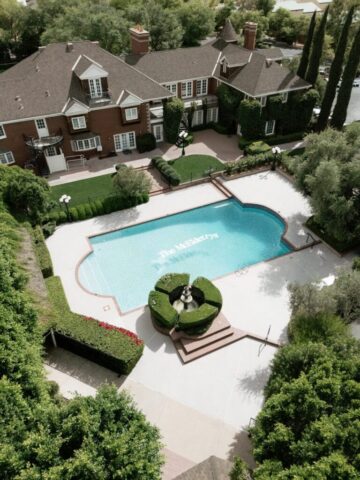 Aerial drone photo of Stonebridge Manor wedding venue Mesa Arizona showing estate gardens and pool