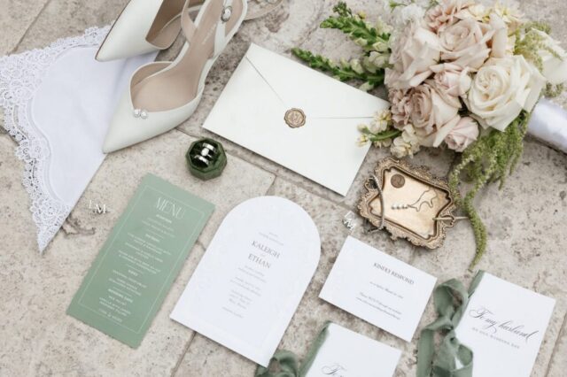 Wedding detail flatlay of rings florals and invitation suite at Stonebridge Manor Mesa Arizona wedding photography