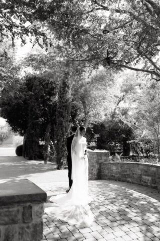 Wedding first touch bride and groom holding hands around corner at Stonebridge Manor Mesa Arizona documentary wedding photographer Meghan GeRue Photo