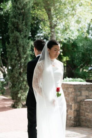 Wedding first touch bride and groom holding hands around corner at Stonebridge Manor Mesa Arizona documentary wedding photographer Meghan GeRue Photo